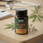 Hebe Vijaya Vati full spectrum capsules on wooden desk with herbal leaves, 150mg capsules for daily wellness