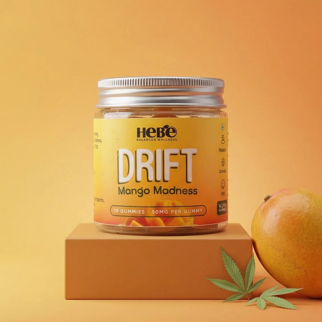 Jar of Hebe Drift Mango Madness gummies on an orange background with a mango and cannabis leaf.