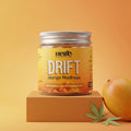 Jar of Hebe Drift Mango Madness gummies on an orange background with a mango and cannabis leaf.
