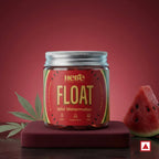Jar of 'Float Wild Watermelon' by Hero on a red background with watermelon slices and leaves.