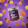Jar of 'Hebe Joy Juice' THC Gummies with colorful gummy bears on a purple background