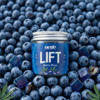 Container labeled 'LIFT Berry Buzz' by HEBE on a background of blueberries
